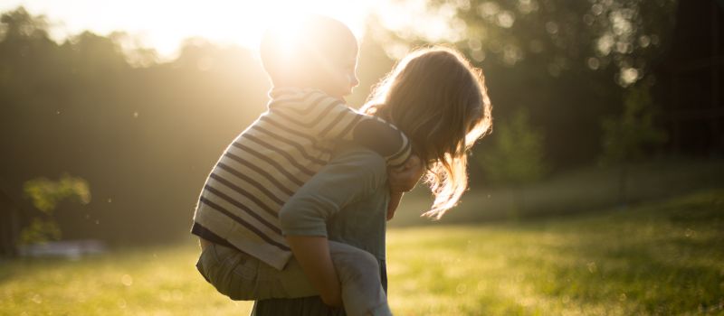 woman carrying a child symbolising the importance of considering the child's best interests in family matters