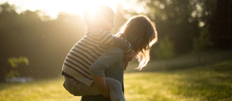 woman carrying a child symbolising the importance of considering the child's best interests in family matters