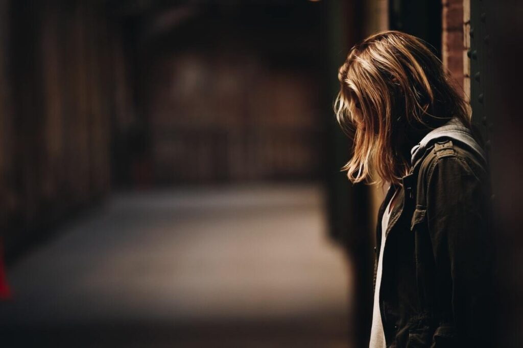 woman with dishevelled hair who is probably a victim of domestic violence