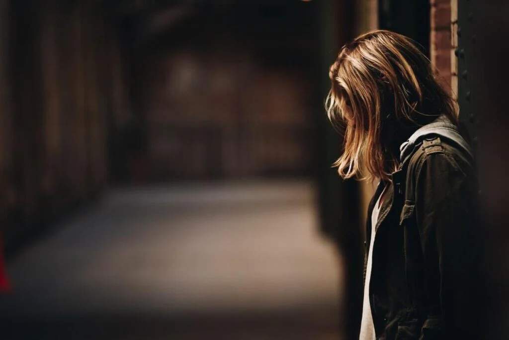 woman with dishevelled hair who is probably a victim of domestic violence