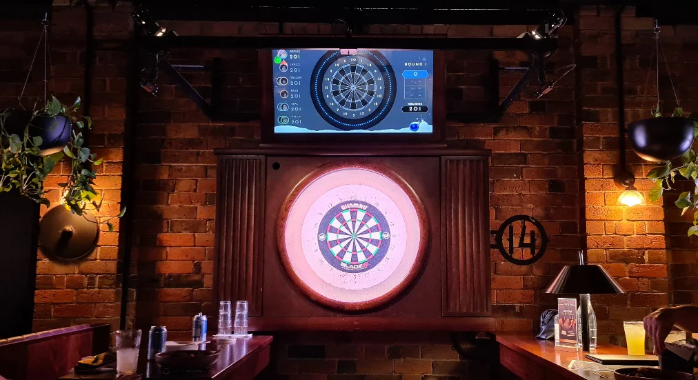 bar with a dartboard in the wall