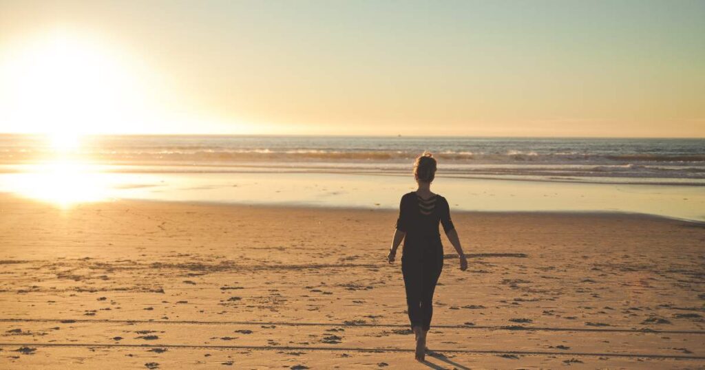 woman walking along the beach