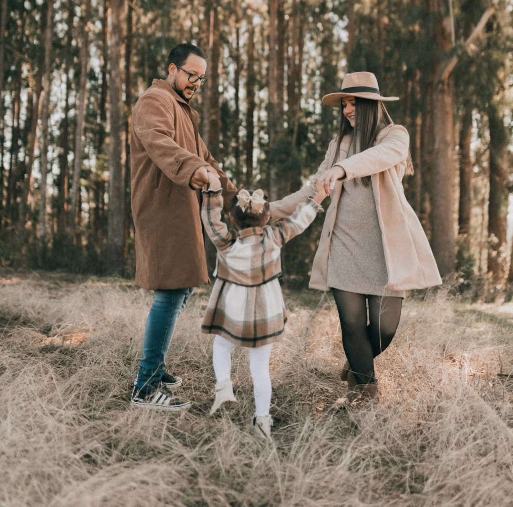 A couple is playing with a child.
