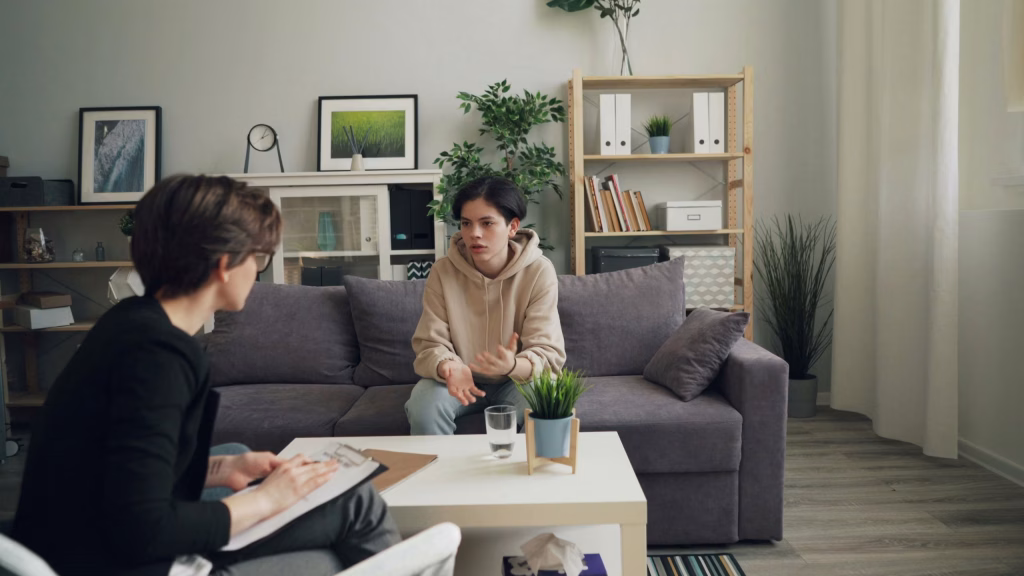 A child is engaged in a discussion with a therapist.